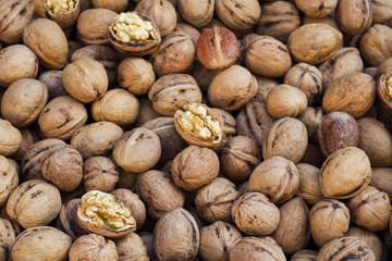 Background of ripe walnuts on the market. Healthy organic food