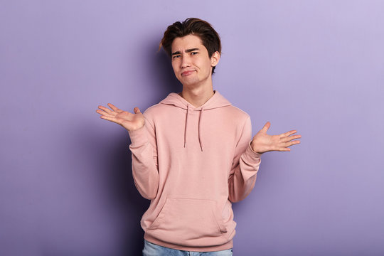 clueless puzzled man doesn't know what to do, close up portrait, isolated blue background, negative feeling and emotion
