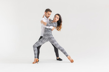 Young love couple dancing social danse kizomba or bachata over white background with copy space