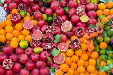 Oranges pomegranate grapefruit lime in the street market. Juicy fresh fruit for fresh juice.