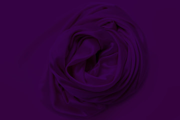 lilac beautiful satin fabric draped with soft folds in a rose, silk cloth background, close-up, copy space