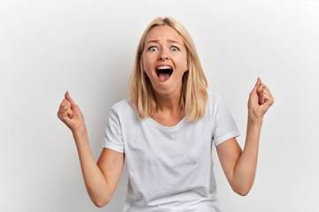 crazy funny girl rejoicing at her victory, close up portrait, studio shot,facial expression, isolated white background, luck concept, student has passed all her exams successfully
