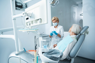 Adult woman lying in dentist chair before treatment
