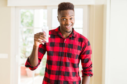 Young african american man drinking a fresh glass of water