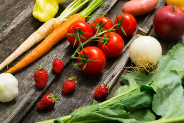 fresh fruits and vegetables on old weathered wooden
