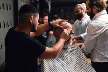 two professional masters working with old man, helping him to be handsome and stylish. close up...