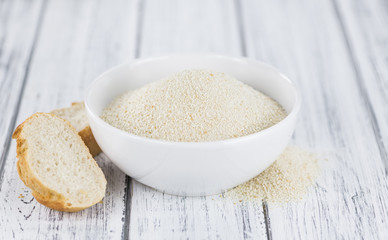 Vintage wooden table with Bread Crumbs (selective focus; close-up shot)