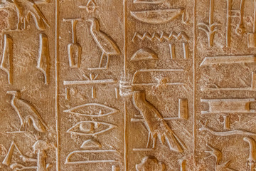 Ancient egyptian hieroglyphs carved on the stone wall