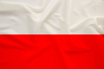 national flag of the country of Poland on gentle silk with wind folds, travel concept, immigration, politics