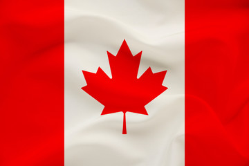 Fototapeta na wymiar Canada national flag on gentle silk with wind folds, travel concept, immigration, politics