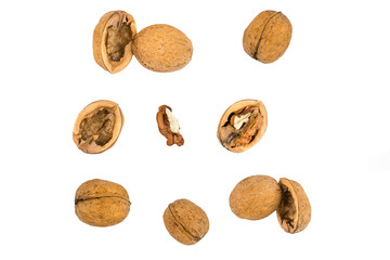 Walnuts isolated on a white background. Cracked walnuts and their shells.