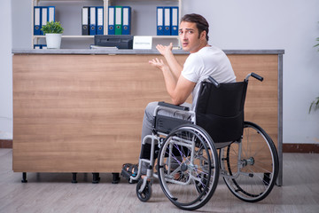 Young man at hospital reception desk