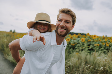 Little girl spending time with her dad in the field