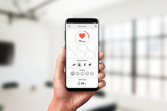 Measuring heart rate app on smart phone in hand. Concept of measuring in office. Modern, flat design app concept.