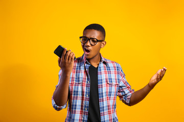 Young handsome man of african american ethnicity wearing checkered shirt posing over isolated background. Portrait of stylish confident male in casual outfit. Close up, copy space.