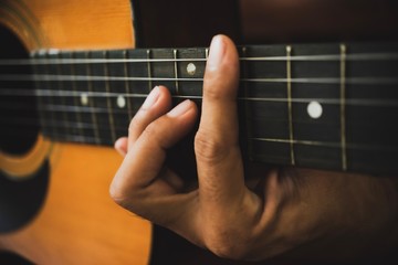 Close up of man hand playing acoustic guitar.