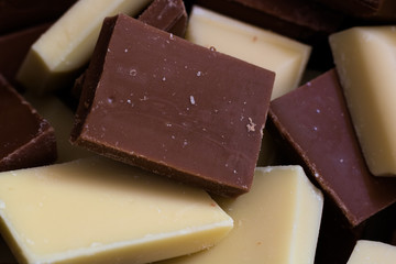 Cubes of milk and white chocolate mix together.