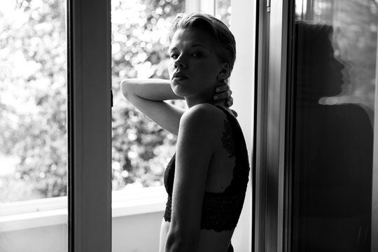 black and white photo model girl with a short haircut very beautiful, professionally posing, very tender