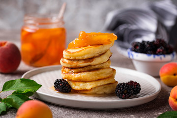 Pancakes with apricot jam and berry