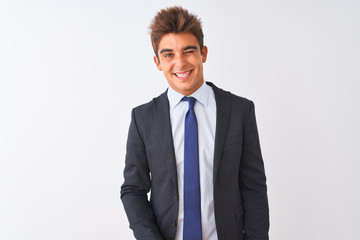 Young handsome businessman wearing suit standing over isolated white background winking looking at...