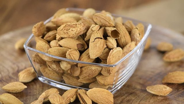 Portion of shelled, roasted Almonds (seamless loopable, 4K)