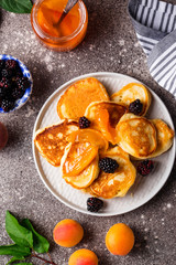 Pancakes with apricot jam and berry