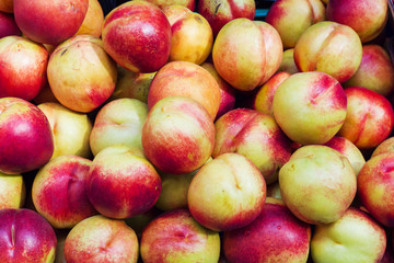 Background of ripe nectarines in the street market.