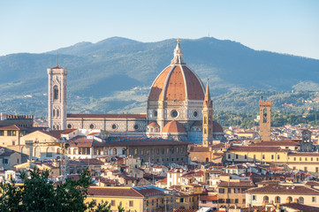 Cathedral of Santa Maria del Fiore and Florence rooftops with mountains