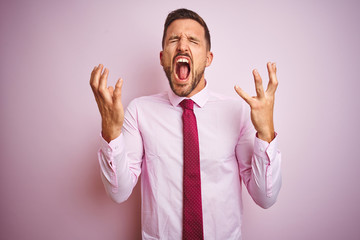 Business man wearing tie and elegant shirt over pink isolated background celebrating mad and crazy...