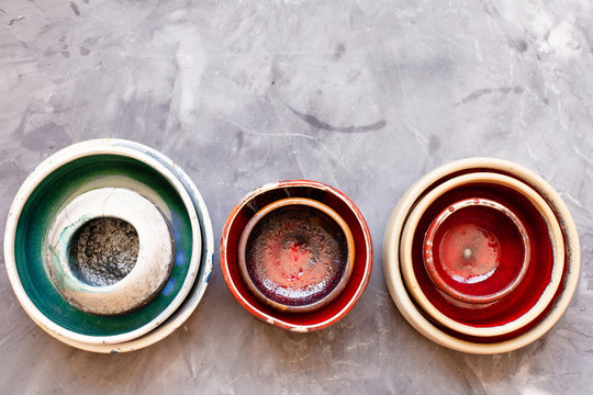 Ceramic tableware on grey background from above