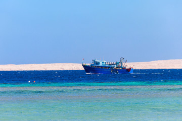 Fishing trawler sails at Red sea in Hurghada, Egypt