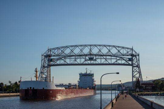 A Ship Passing Under Lift Bridge On Lake Superior