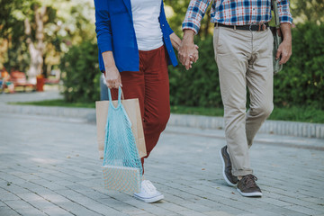 Man and woman walking and holding hands stock photo