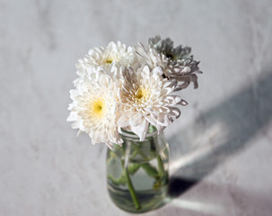 White Flower bouquet in a Vase on wooden table