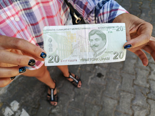 Twenty Turkish Lira in the hands of a girl
