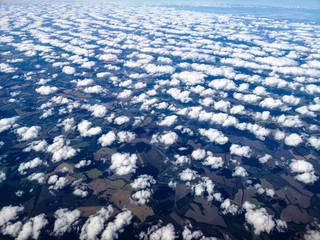 Obraz premium Clouds above the ground view from an airplane as a background