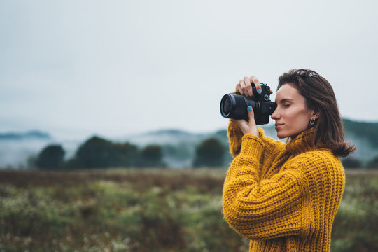 photographer traveler take photo on video camera closeup on background autumn froggy mountain, tourist shooting nature mist landscape outdoor, hobby concept copy space mockup