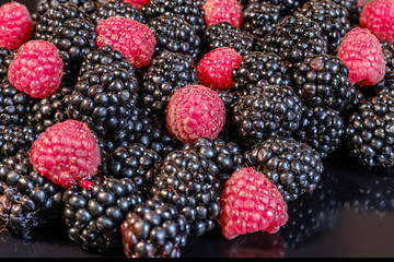 Ripe and fresh blackberry and raspberries, sweet red raspberries over blackberry, berries food