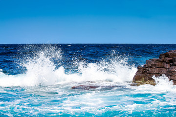 sea crushing on rock on the coast of San Pietro island, Sardinia