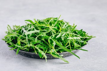 Fresh organic green leaves of arugula, ingredient for healthy salad