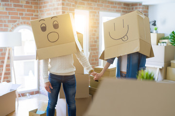 Funny couple wearing cardboard boxes with fun crazy emoji faces over head