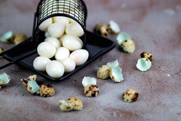 Quail eggs in a basket, with quail egg shells around the basket