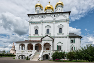 The main entrance to the temple on the background of volumetric clouds. Russian shrines. Joseph-Volotsky Monastery in Teryaev. Moscow region, Teryaevo.
