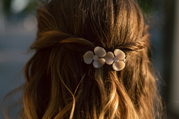 beautiful plastic hairpin delicate peach color with flowers for the bride on the girl s hair. wedding accessory - obrazy, fototapety, plakaty
