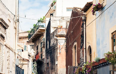 Travel to Italy -  historical street of Acitrezza, Catania, Sicily, facade of old buildings.