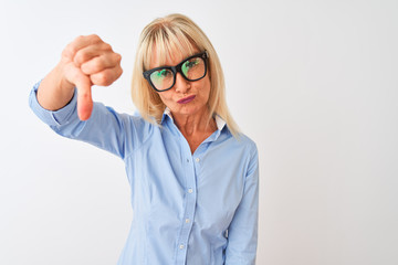 Middle age businesswoman wearing glasses and shirt standing over isolated white background with angry face, negative sign showing dislike with thumbs down, rejection concept