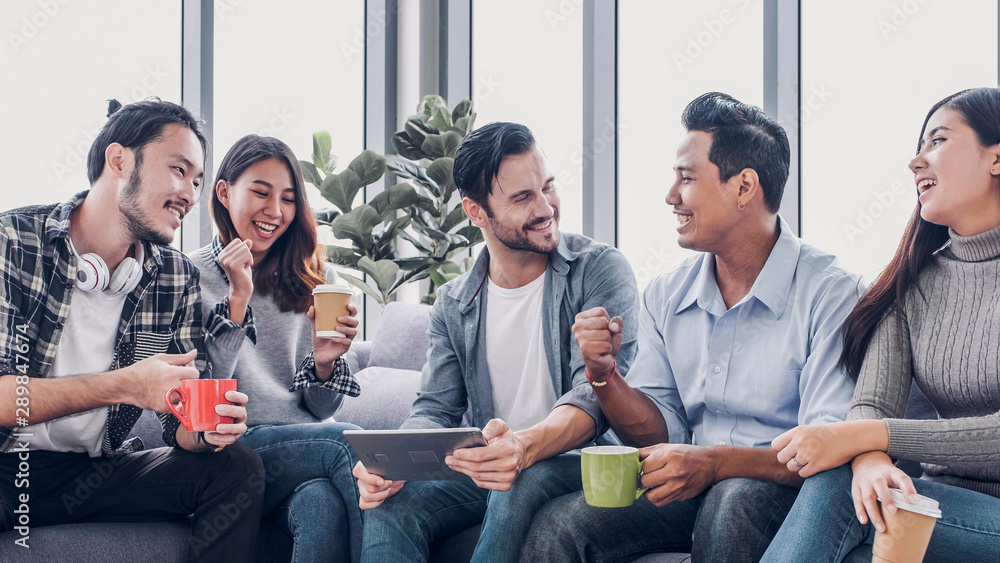 Poster creative office,designer team use tablet in casual meeting and arms up for project success at sofa a