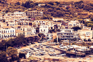Naklejka premium Travel to Italy - aerial view of Acitrezza on sunset, Catania, Sicily, facade of old buildings on the seafront, harbor with fisher boats.
