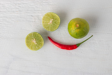 Red chilli and lemon For cooking Thai food on white wooden table
