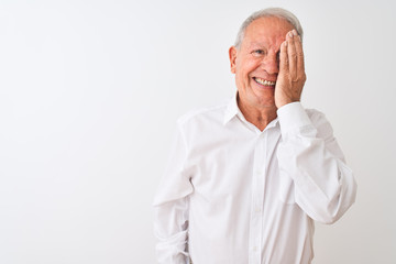 Obraz premium Senior grey-haired man wearing elegant shirt standing over isolated white background covering one eye with hand, confident smile on face and surprise emotion.